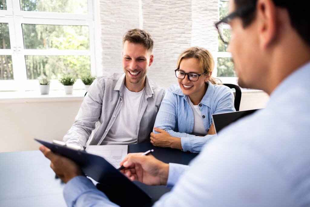 Couple reviewing their estate plan with a lawyer.